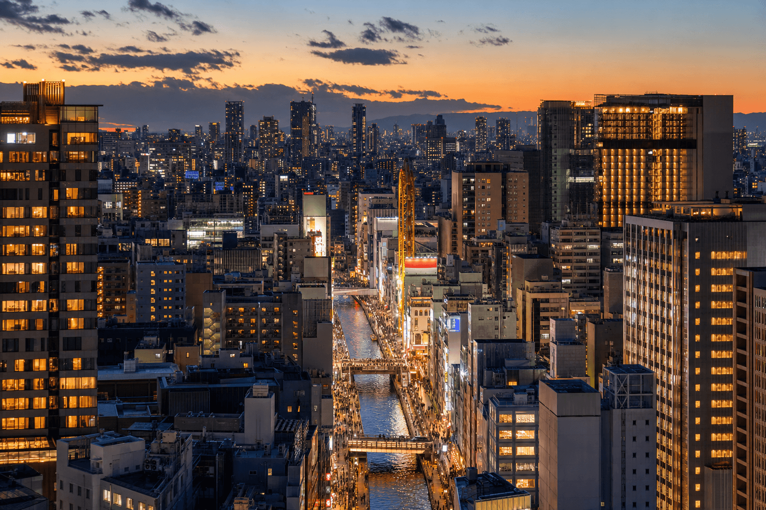 Boutique hotel in Namba, Osaka, with warm lights glowing onto a lantern-lit street at dusk